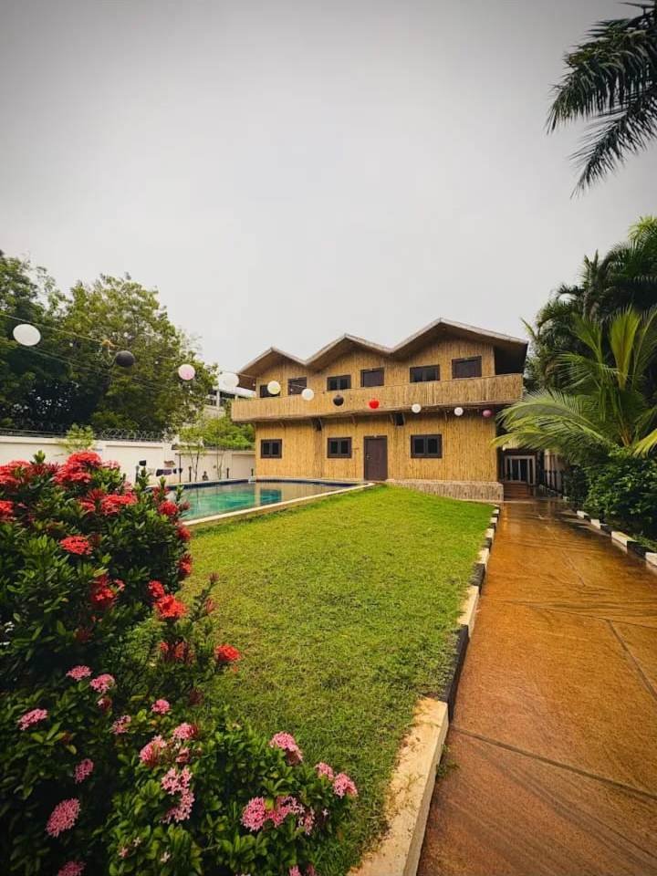 Bamboo guest house beside the lawn and pool