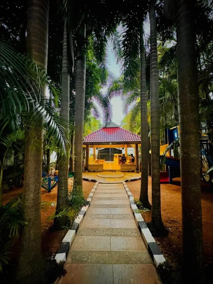 Palm-lined garden path to the gazebo