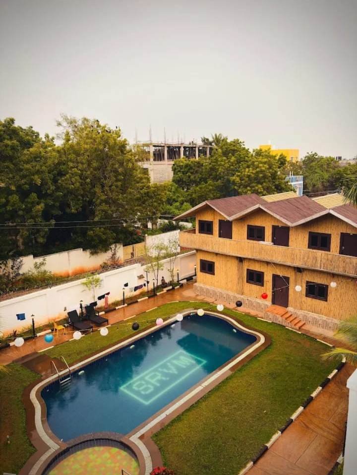 Pool and bamboo guest house from above
